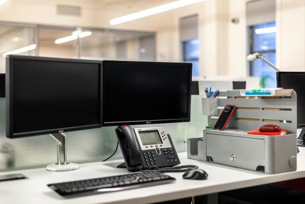 Dual monitor set-up at an employee's desk which enables greater productivity