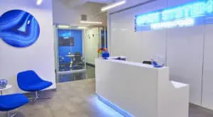 office reception with blue chairs and neon lighting