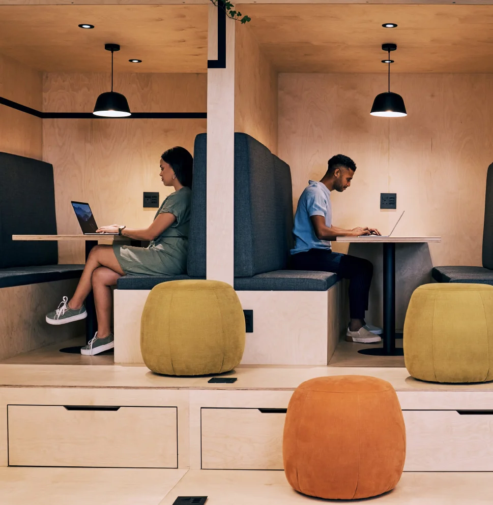 Office space with collaboration pods, movable seating, and ample storage.