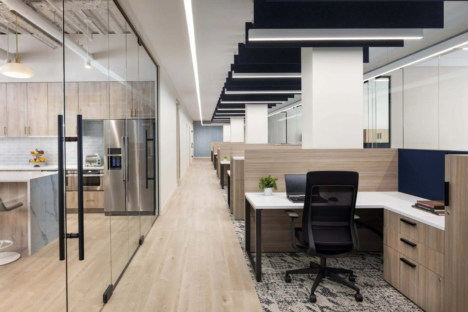Office cubicles lined with glass partitioned offices