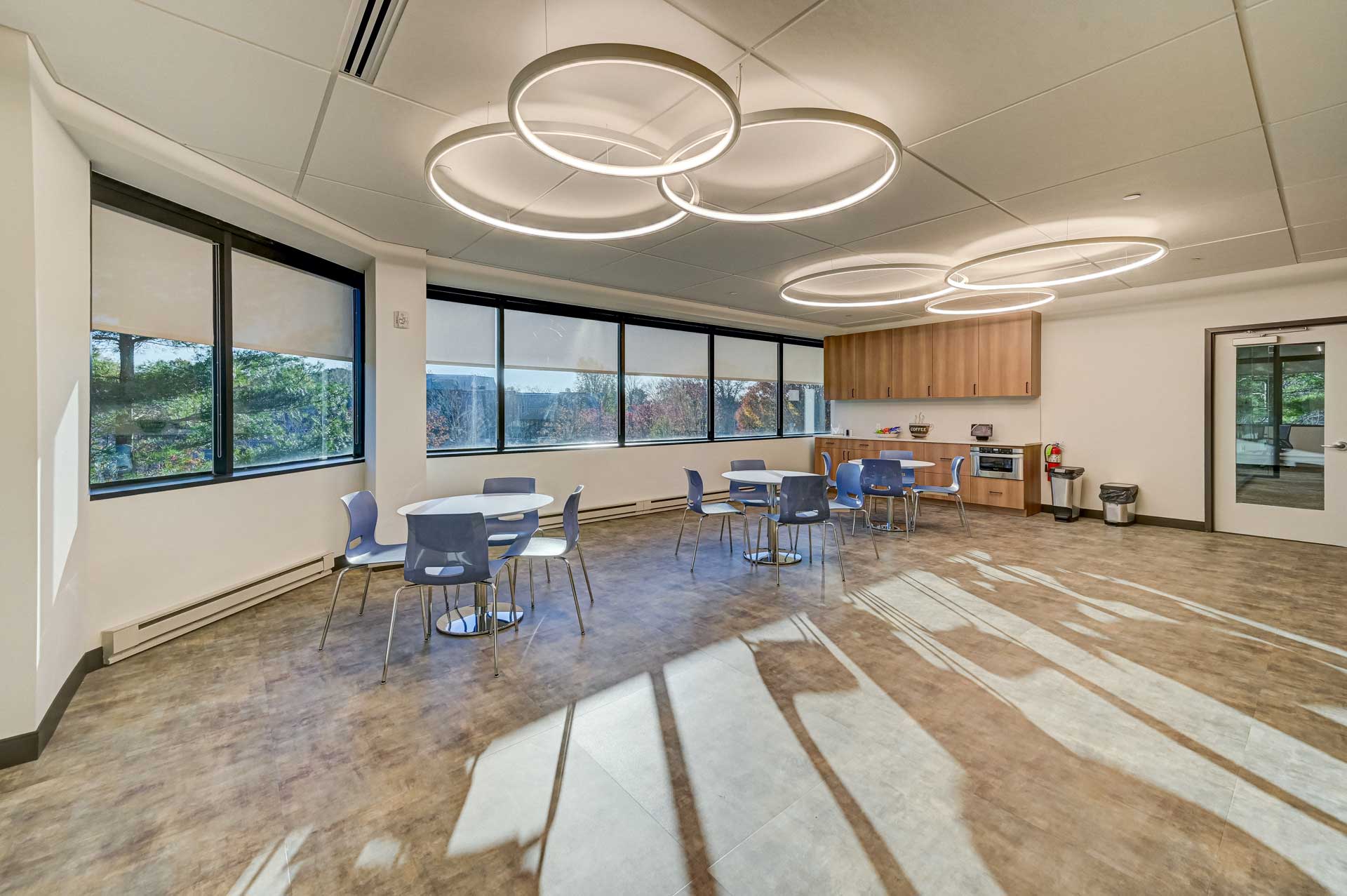 Light filled modern workplace designed by RI Workplace with circular ceiling lights